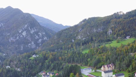 Aerial-View-Of-Mountain-Forests-With-Reveal-Of-Market-Town-In-Eisenkappel-Vellach