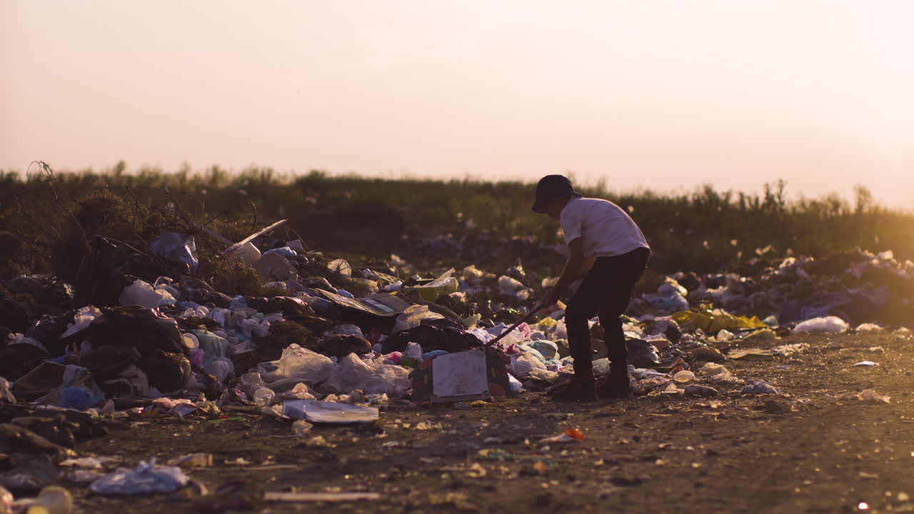 A child playing in a landfill