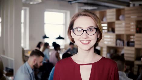 happy confident european young businesswoman smiling at camera. confident female boss posing in office background 4k