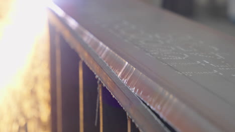 beam cutting a metal plate in slow motion close up shot