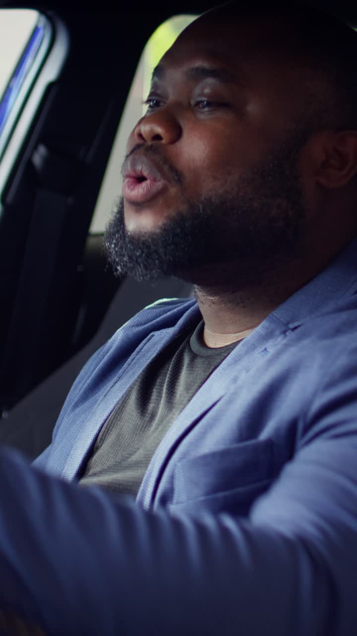 African American Man Talking and Smiling Inside Car