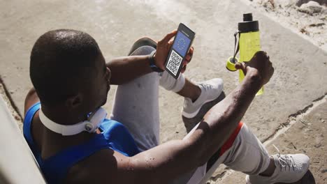 Man-in-street-holding-smartphone-with-covid-vaccination-certificate,-eu-flag-and-qr-code-on-screen