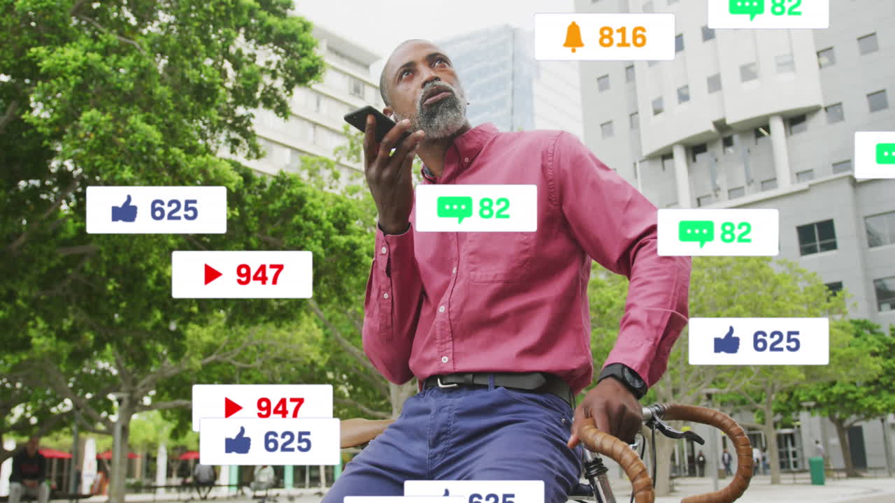 animación de texto e iconos de redes sociales sobre hombre afroamericano usando teléfono inteligente en la ciudad