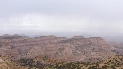 Drone-flies-over-rocky-dessert-mountains,-canyon,-Utah,-United-states