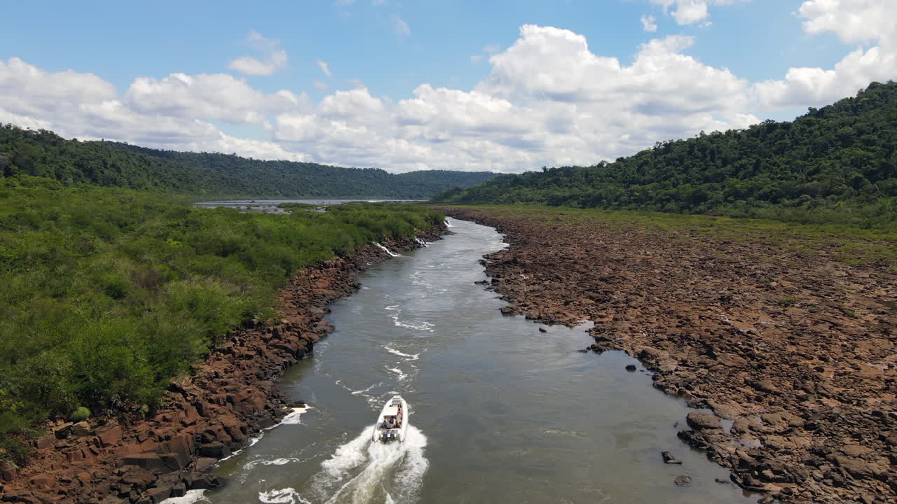 Boat nears Mocon&aacute; Falls: Captivating view on a clear day with a drone