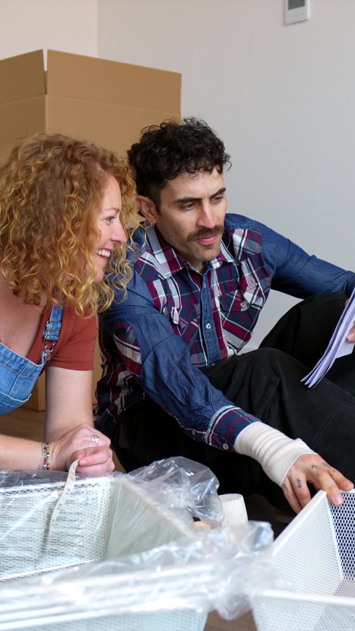Couple Assembling Furniture Together in New Home