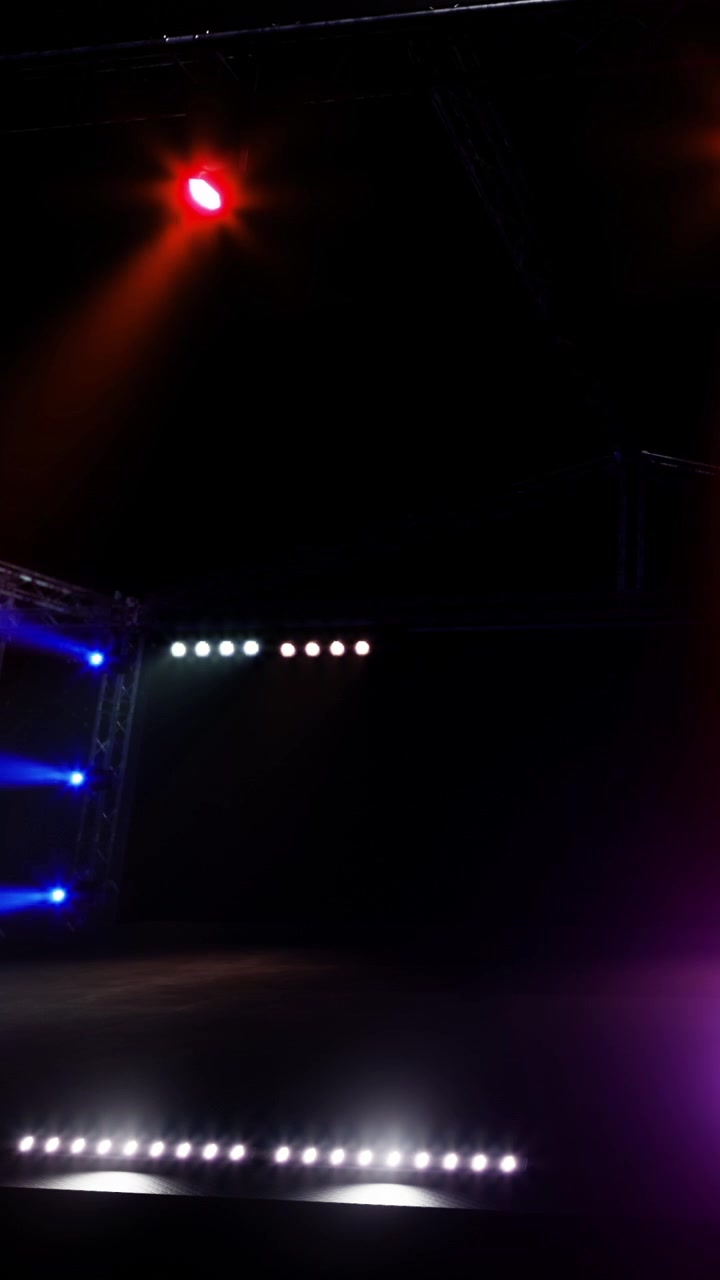 Stage with colorful lights shining in dark space during a performance