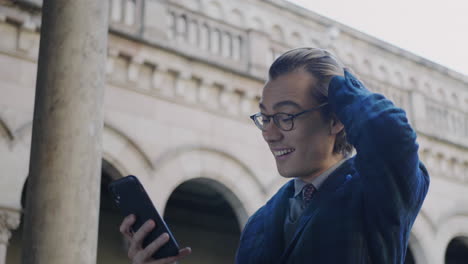 student reading good news on phone