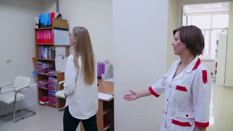 doctor inviting patient. ophthalmologist with client in hospital