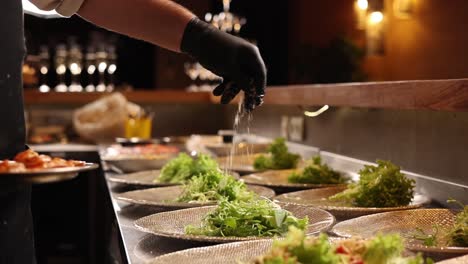 chef preparing salads at a buffet