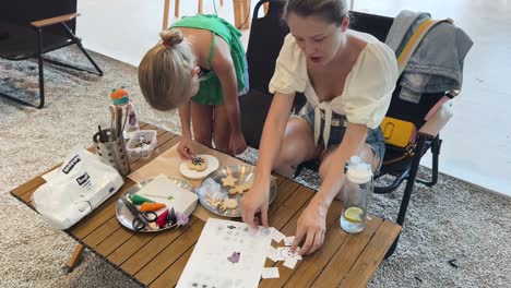 mom and daughter decorating cookies