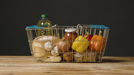 Studio-Shot-Of-Basic-Food-Items-In-Supermarket-Wire-Shopping-Basket-12