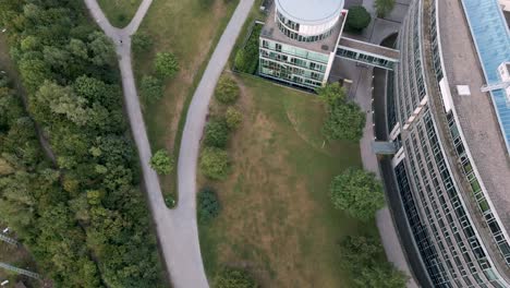 Cologne,-Germany---Aerial-bird-view-flight-of-media-park-in-Köln-City-Center-with-green-grass,-trees-and-calm-atmosphere-around-busy-business-center-and-offices