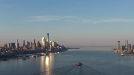 an aerial view of lower manhattan and new jersey from over the hudson river at sunrise