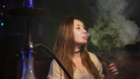 woman enjoying a hookah session at a lounge