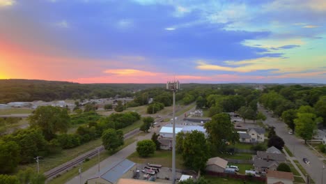 cell tower at sunset with colorful sky in janesville, wisconsin