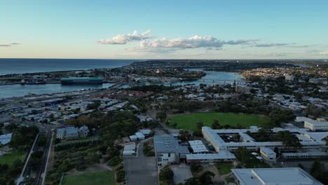 drone flying over perth city and harbor in western australia - dolly shot