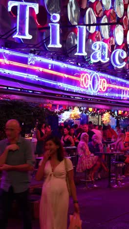 crowded street scene with neon lights at night