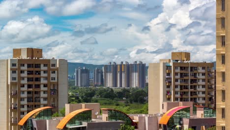 high rise buildings, time lapse of thick clouds passing over a city and distant mountains in background, pune, maharashtra, india