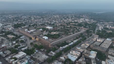 aerial drone rotating shot over residential houses in umerkot city, tharparkar, pakistan during evening time