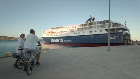 cyclists wait to board greek car ferry ship docked pelopennese port