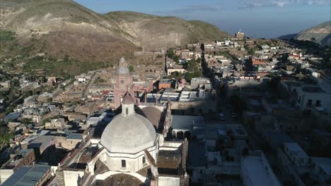 Aerial-orbit-shot-of-the-Church-of-Real-de-Catorce-at-sunrise,-San-Luis-Potosi-Mexico