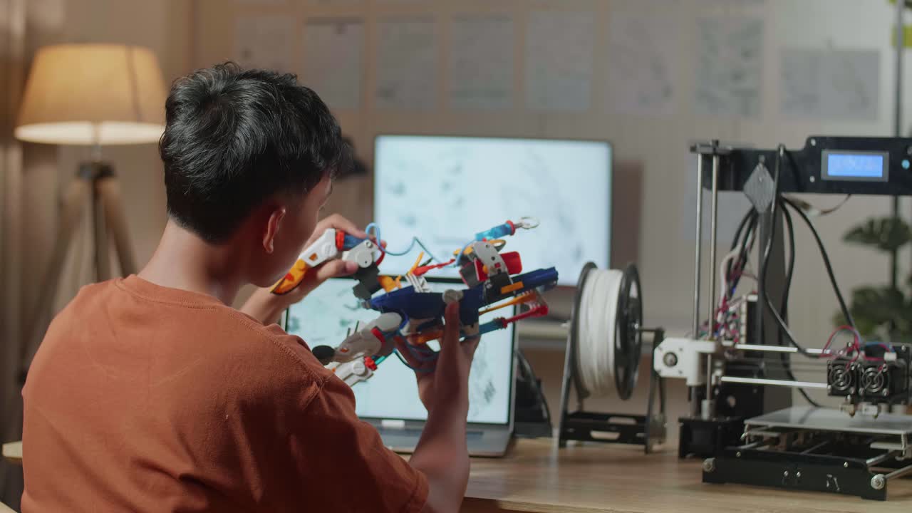 estudiante trabajando en un brazo robótico impreso en 3d