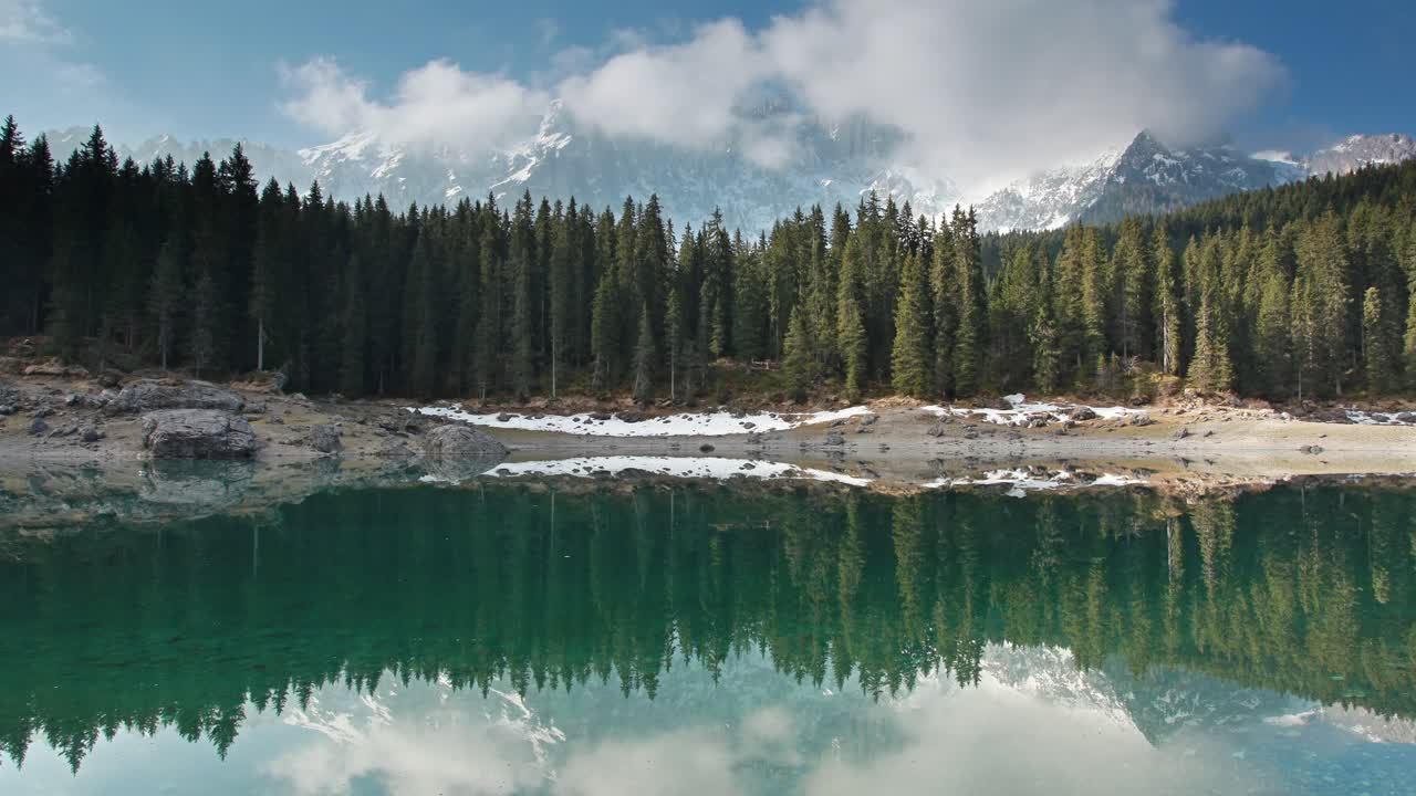 Lago di Carezza in the Dolomites: mountain lake and pine forest ladscape time lapse, South Tyrol, Italy