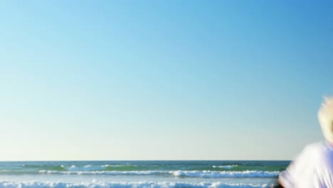 senior man doing exercise on beach