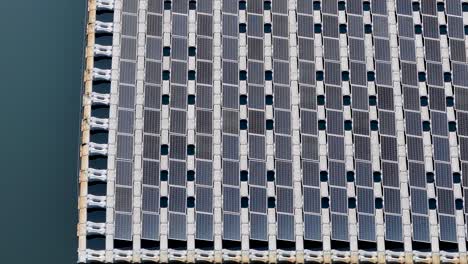 low flight over a large floating solar panel array on a lake in new jersey