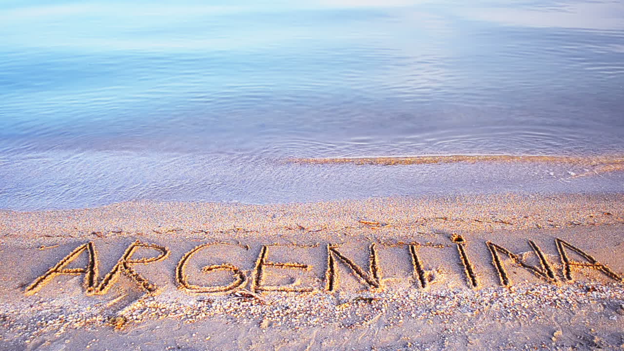 Innskriften Argentina på sand. Innskrift på sand, stranden