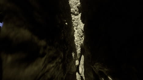 natural rock formation with narrow gap illuminated by sunlight