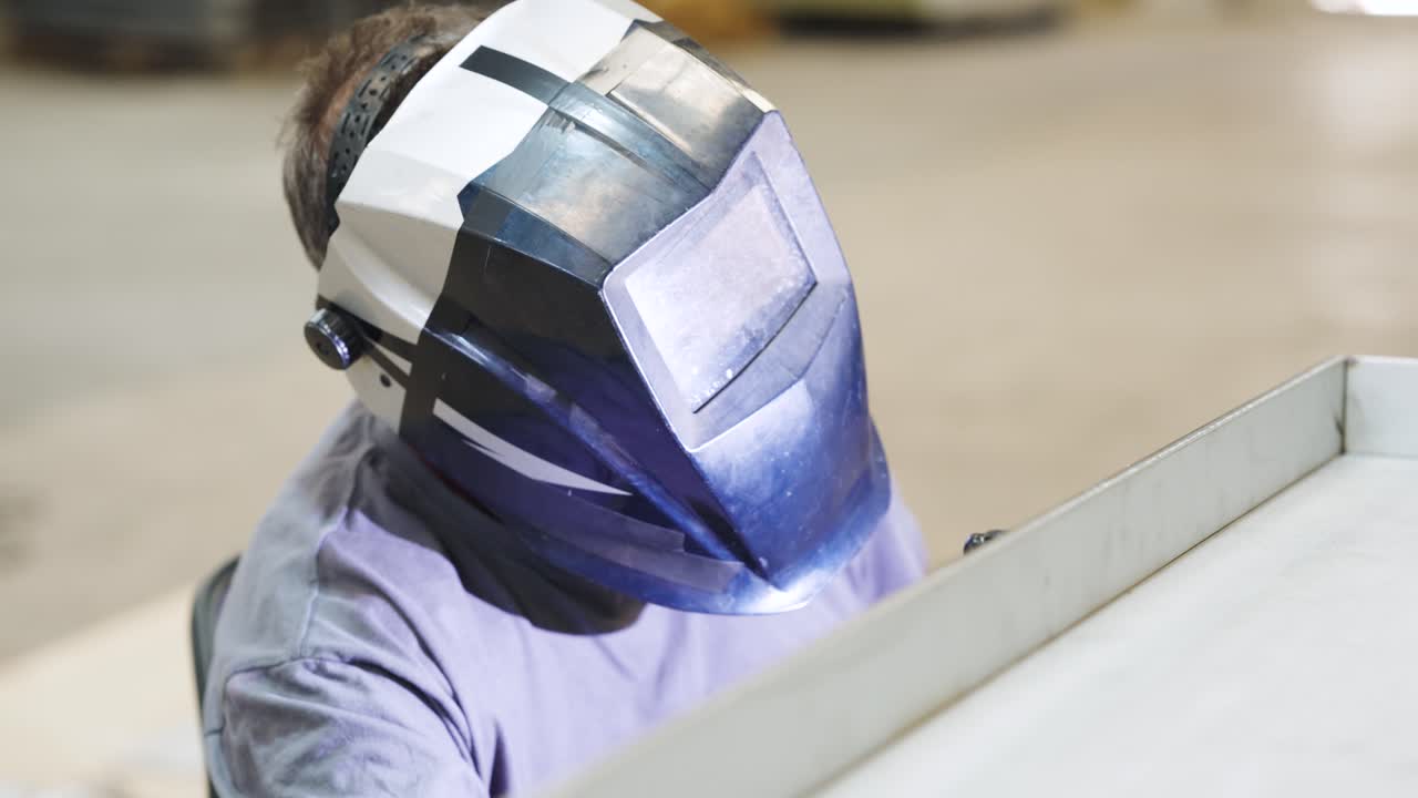 Welder wearing protective mask