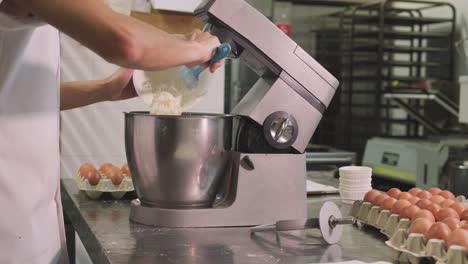 Confectioner-preparing-dough-in-mixer