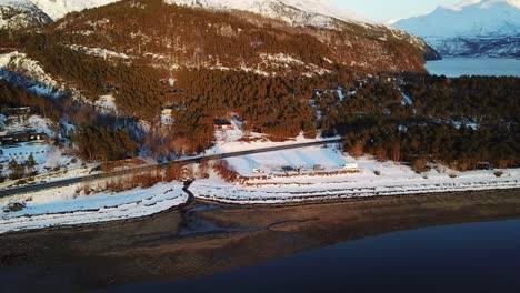 Drone-aerial-footage-over-arctic-sea-waves-to-beach-where-campers-and-vanlifers-keep-their-vans