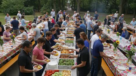 large outdoor buffet gathering with many people enjoying food
