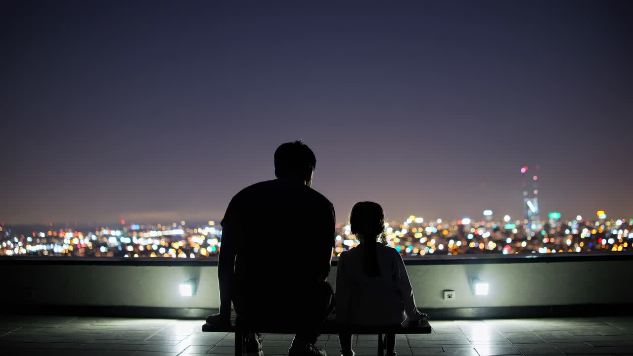 Father and Daughter Enjoying Night City View