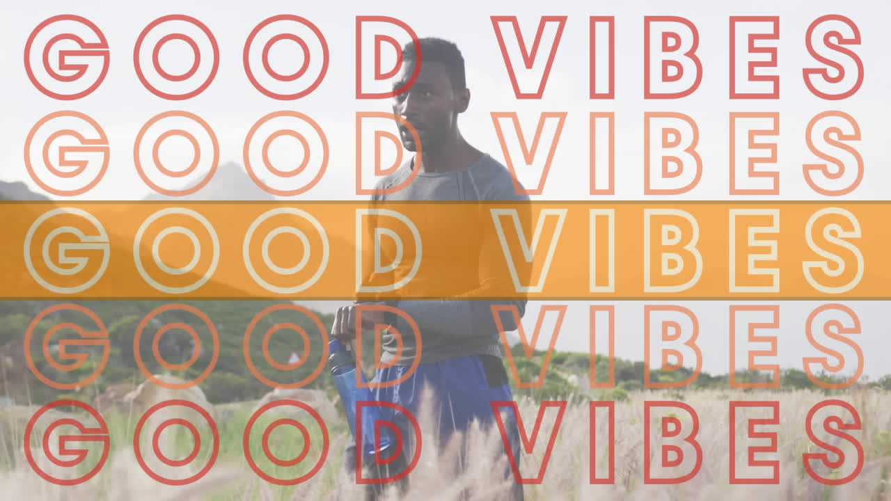 Animation of the words good vibes in red and orange over man exercising in mountains checking watch