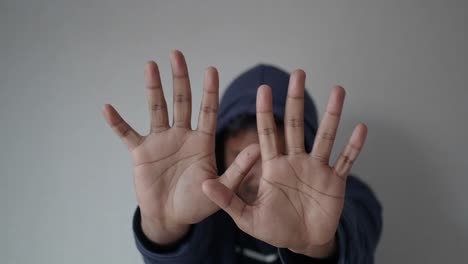 person holding up hands in a defensive posture