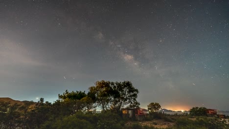 timelapse view of magical milky way shooting stars. beautiful imelapse night sky over lantau island coastal hong kong.