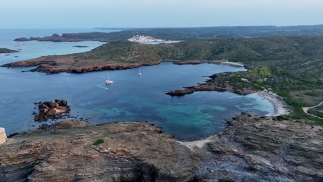 a drone shot of a small cylidrical medievel coasta guard tower on menorca. spain, europe,.