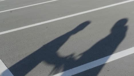 shadows of people on a parking lot