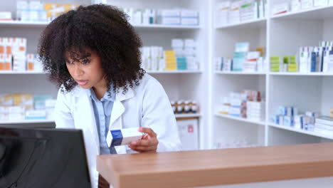 a black female pharmacist selling medication