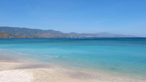 beautiful scenic view of crystal clear turquoise ocean water and sandy white beach at cristo rei in dili, timor-leste, southeast asia