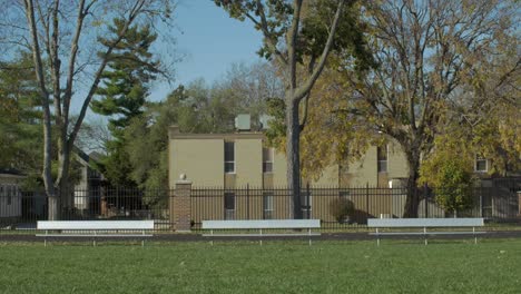 empty park benches facing away from the street