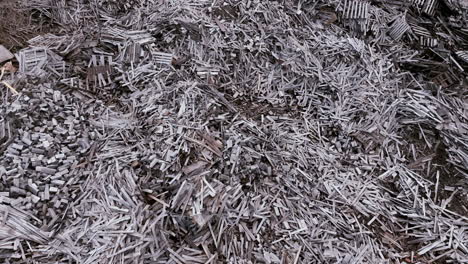 aerial footage slowly flying over piles and piles of old wood at a factory.
