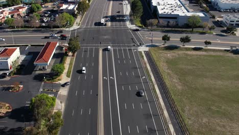 Light-traffic-on-a-major-roadway---aerial-forward-follow