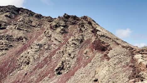 Pan-shot-of-a-volcanic-creater-against-blue-sky-at-a-spent-volcano