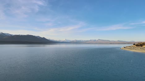 drone point of view of mount cook mountain range with the beautiful turquoise waters of lake pukaki, south island, new zealand