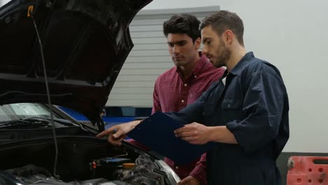 mecánicos que revisan un motor